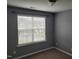 Carpeted bedroom features a large window with blinds that fills the space with natural light at 4202 Cherry Blossom Cir, Durham, NC 27713