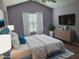 This spacious bedroom features a plush queen bed, ceiling fan, and a wall-mounted television at 4202 Cherry Blossom Cir, Durham, NC 27713