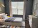 Modern bedroom features a full bed, plush carpet, dresser, and great natural light at 4202 Cherry Blossom Cir, Durham, NC 27713