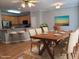 Staged dining room area with seating for six, kitchen view, and updated decor at 4202 Cherry Blossom Cir, Durham, NC 27713