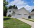 Townhome exterior with a two-car garage and a well-manicured lawn at 4202 Cherry Blossom Cir, Durham, NC 27713