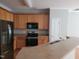 Functional kitchen with stainless steel appliances, wooden cabinets, and laminate countertops at 4202 Cherry Blossom Cir, Durham, NC 27713