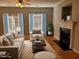 Bright living room featuring a fireplace, neutral furniture, hardwood floors, and ample natural light at 4202 Cherry Blossom Cir, Durham, NC 27713