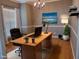 Bright office space with wood floors, large desk, stylish decor, and natural light at 4202 Cherry Blossom Cir, Durham, NC 27713