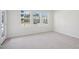 Carpeted bedroom is flooded with light from the large windows at 4717 Cypress Tree Ln, Raleigh, NC 27612