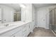 Double vanity bathroom with a large mirror and shower at 501 Hanover Shore Ln, Raleigh, NC 27610