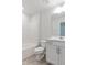 Clean bathroom with white vanity, tub, and tile flooring at 501 Hanover Shore Ln, Raleigh, NC 27610