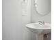 Pedestal sink in a small, updated bathroom at 501 Hanover Shore Ln, Raleigh, NC 27610