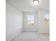 Well-lit bedroom with two windows and gray carpeting at 501 Hanover Shore Ln, Raleigh, NC 27610