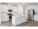 Modern kitchen with white cabinets and stainless steel appliances at 501 Hanover Shore Ln, Raleigh, NC 27610