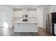 Modern kitchen with white cabinets and stainless steel appliances at 501 Hanover Shore Ln, Raleigh, NC 27610