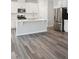 Modern kitchen features island, stainless steel appliances, and white cabinets at 501 Hanover Shore Ln, Raleigh, NC 27610