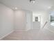 Spacious loft with neutral carpeting, window, and built-in shelving at 501 Hanover Shore Ln, Raleigh, NC 27610