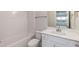 Well-lit bathroom with a tub, toilet, and vanity featuring a white countertop and modern faucet at 514 Glenkirk Pl, Garner, NC 27529