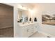Modern bathroom featuring double sinks, white cabinets, and stylish fixtures adjacent to closet at 514 Glenkirk Pl, Garner, NC 27529