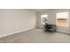 Bright bedroom featuring neutral carpet, paint, and baseboards, with a desk positioned between two windows at 514 Glenkirk Pl, Garner, NC 27529
