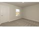 Carpeted bedroom featuring a window providing natural light and a view of the exterior at 514 Glenkirk Pl, Garner, NC 27529