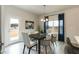 A dining area features a modern table and chairs, stylish lighting, and a view to the outside at 514 Glenkirk Pl, Garner, NC 27529
