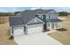 Aerial view of a two-story home with a three-car garage, complemented by a well-manicured yard at 514 Glenkirk Pl, Garner, NC 27529