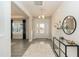 Bright and airy foyer with wood floors, neutral walls, modern console table and a view into the living area at 514 Glenkirk Pl, Garner, NC 27529