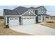 Charming two-story home featuring a three car garage and stylish stone accents at 514 Glenkirk Pl, Garner, NC 27529