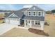 Beautiful two-story home showcasing a welcoming entrance and a spacious three car garage at 514 Glenkirk Pl, Garner, NC 27529