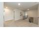 Hallway landing with neutral carpet and decorative railing at 514 Glenkirk Pl, Garner, NC 27529