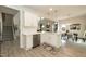 Bright, modern kitchen featuring white cabinets, stainless steel dishwasher, and an open floor plan at 514 Glenkirk Pl, Garner, NC 27529