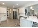 Open kitchen featuring stainless steel appliances, a large island with a sink, and white cabinetry at 514 Glenkirk Pl, Garner, NC 27529