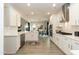 Bright, modern kitchen with white cabinetry, stainless steel appliances, and an open concept layout at 514 Glenkirk Pl, Garner, NC 27529