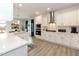 Modern kitchen featuring white cabinets, stainless steel appliances, and a view into the dining area at 514 Glenkirk Pl, Garner, NC 27529
