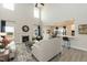 Spacious living room with a fireplace, tall ceilings, lots of natural light, and an open view into the kitchen at 514 Glenkirk Pl, Garner, NC 27529