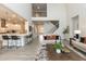 A living room flows into kitchen with high ceilings, neutral colors, modern decor, and an open staircase at 514 Glenkirk Pl, Garner, NC 27529