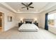 Serene main bedroom with a tray ceiling, a ceiling fan and carpeted flooring, illuminated by bedside lamps and natural light at 514 Glenkirk Pl, Garner, NC 27529