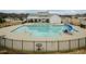 Community pool with a slide, tables, chairs, and a fenced area at 514 Glenkirk Pl, Garner, NC 27529