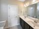 Bathroom with double vanity, dark cabinets, and a toilet at 55 Oxer Dr, Youngsville, NC 27596