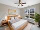 Virtually staged bedroom with light wood furniture and large window at 55 Oxer Dr, Youngsville, NC 27596