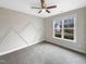 Spacious bedroom with large window and geometric wall design at 55 Oxer Dr, Youngsville, NC 27596