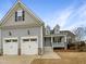 Two-story home with gray siding, two-car garage, and a front porch at 55 Oxer Dr, Youngsville, NC 27596