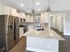 Modern kitchen with stainless steel appliances and granite island at 55 Oxer Dr, Youngsville, NC 27596