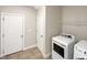 Bright laundry room, washer, dryer, and storage at 55 Oxer Dr, Youngsville, NC 27596