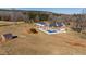 Aerial view showcasing home, pool, and surrounding landscape at 5765 G Snow Camp Rd, Graham, NC 27253