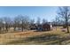 View of home's rear, showcasing a large yard and pond at 5765 G Snow Camp Rd, Graham, NC 27253