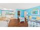 Basement with light blue walls, a living area, and a kitchen at 5765 G Snow Camp Rd, Graham, NC 27253