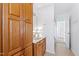 Bathroom with a wooden cabinet, a sink, and access to another room at 5765 G Snow Camp Rd, Graham, NC 27253