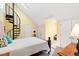 Bedroom with a spiral staircase, and a black metal bed frame, with access to closets at 5765 G Snow Camp Rd, Graham, NC 27253