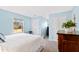 Light blue bedroom with double closets and a window at 5765 G Snow Camp Rd, Graham, NC 27253
