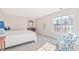 Bright bedroom featuring a comfortable bed, armchair, and large window at 5765 G Snow Camp Rd, Graham, NC 27253