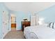 Bedroom with light blue walls, a white metal bed frame, and access to a bathroom at 5765 G Snow Camp Rd, Graham, NC 27253