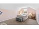 Cozy bedroom with light pink walls and window at 5765 G Snow Camp Rd, Graham, NC 27253